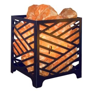 Himalayan Salt Lamp in decorative metal basket with natural orange salt crystals glowing